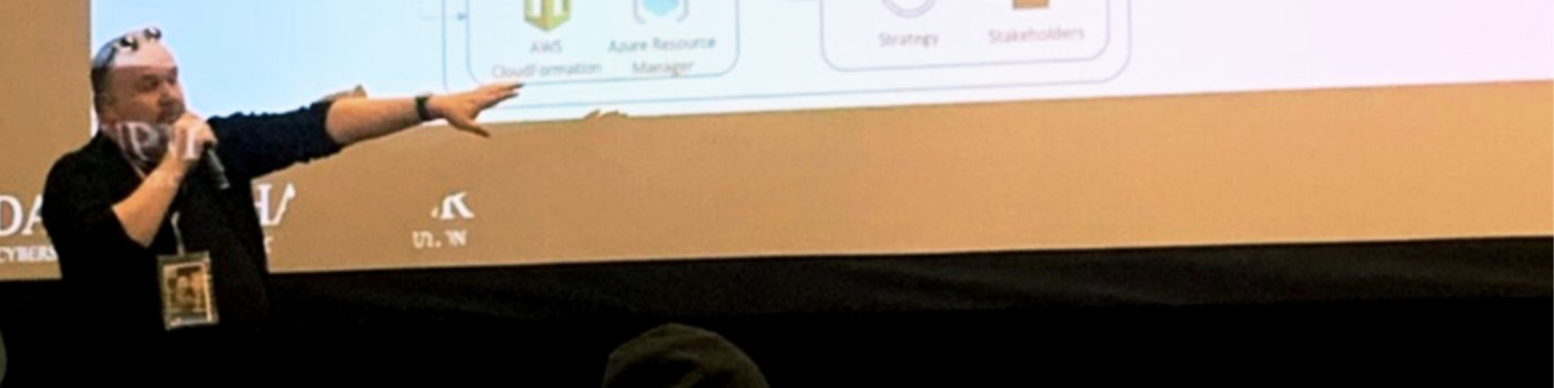 Dan Schaupner speaking and pointing to a projected technology presentation